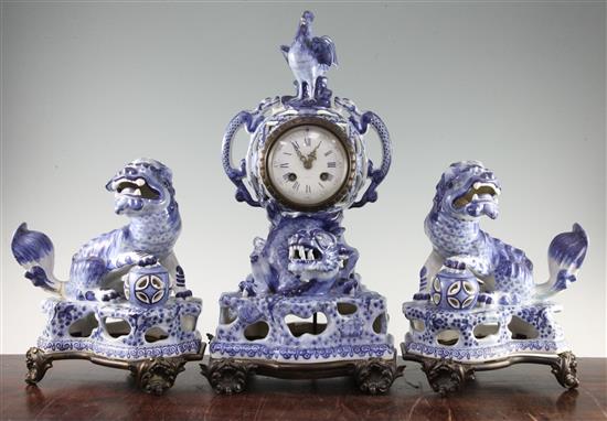 A 19th century French faience clock garniture, clock 18in.